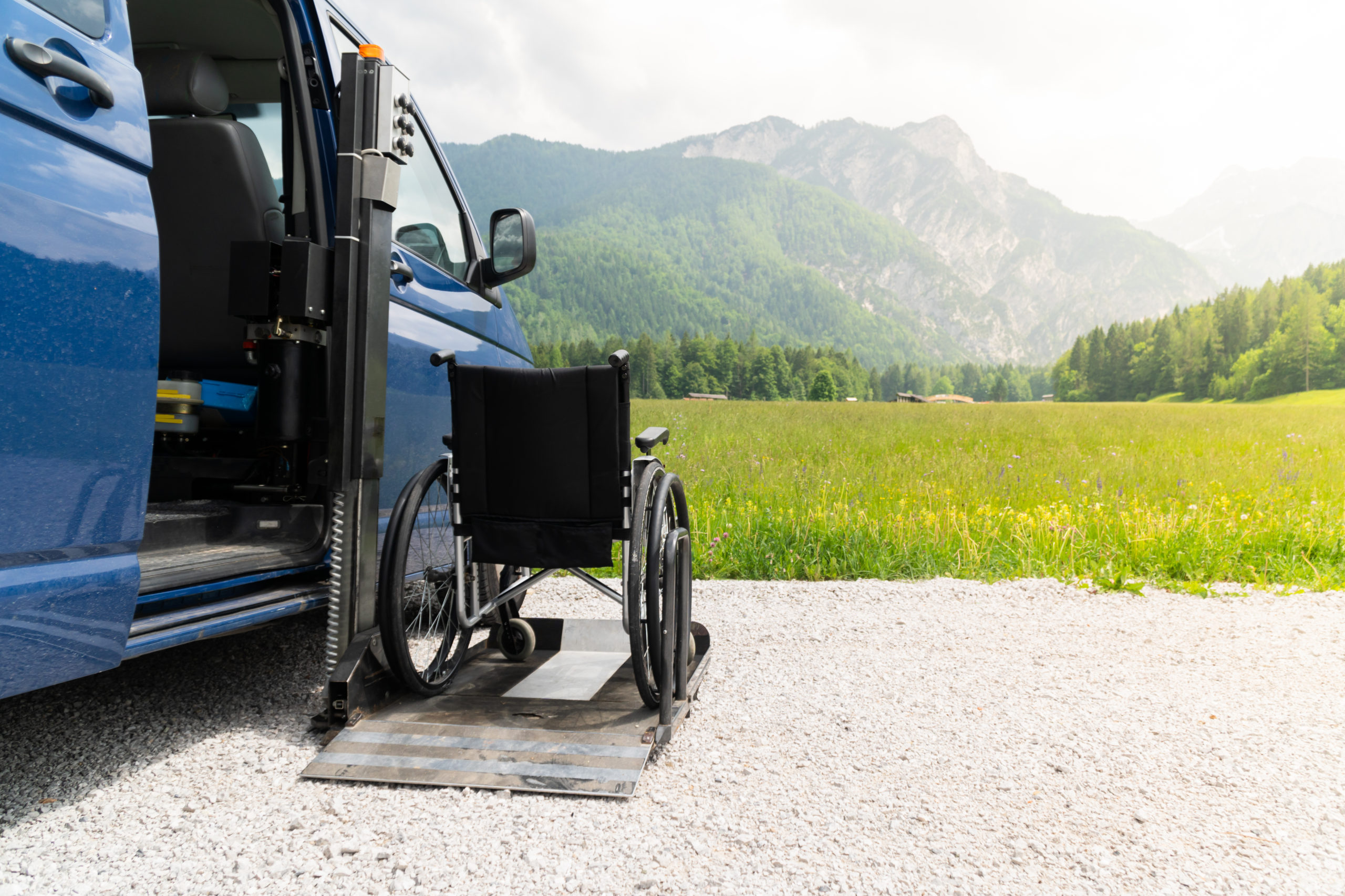 Mechanical lift transporting a wheelchair into a car