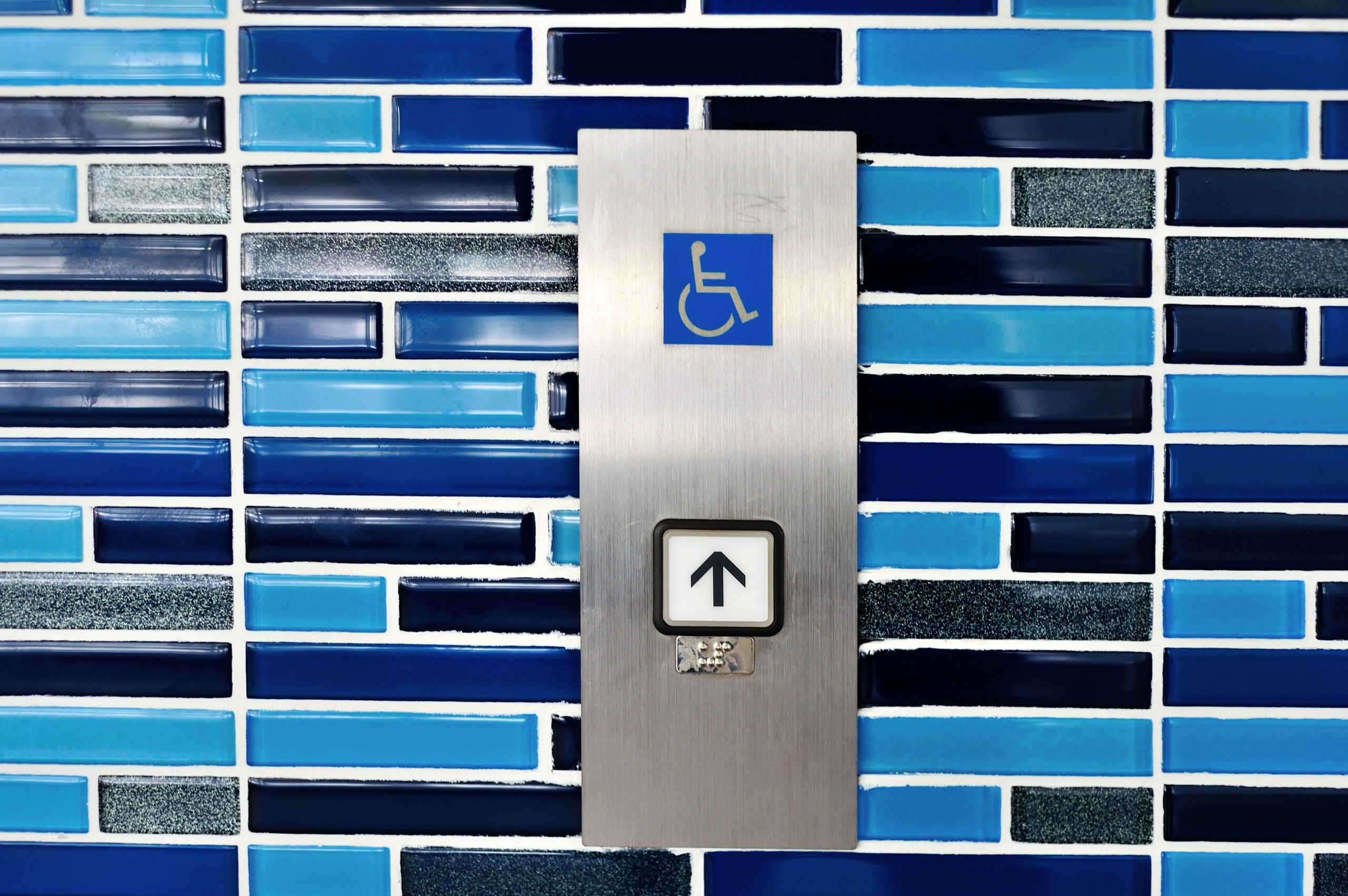 Button for a wheelchair elevator.